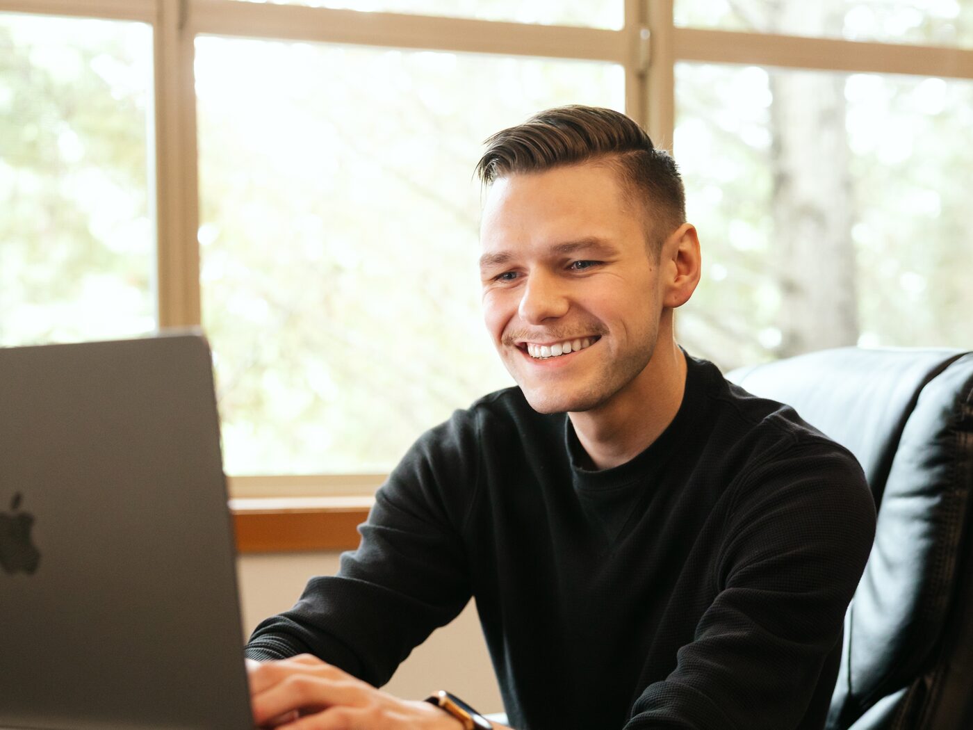 Leo Speaks on a client call at his desk