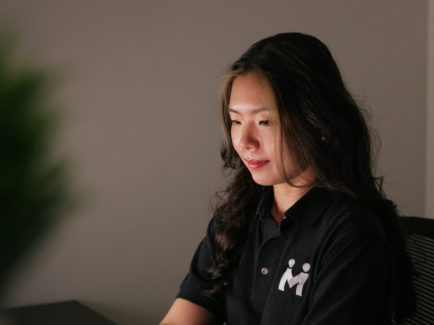 Vivian Liu focused on a website design at her workstation