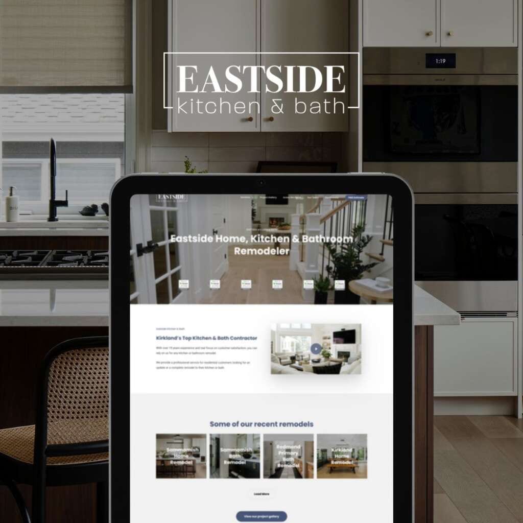 Eastside Kitchen & Bath website on tablet with renovated kitchen and modern appliances in background