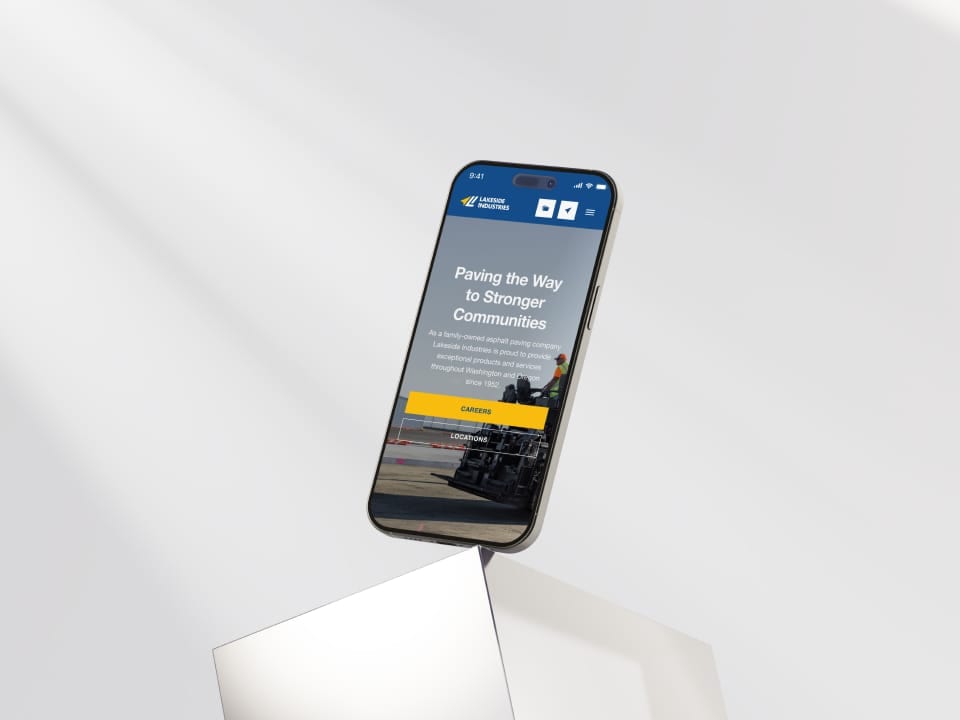 Smartphone with Lakeside Industries website on reflective surface