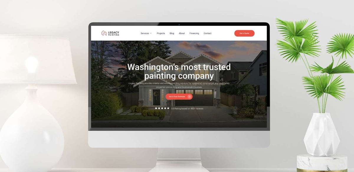 Computer monitor displaying Legacy Painting website with house image and free estimate button