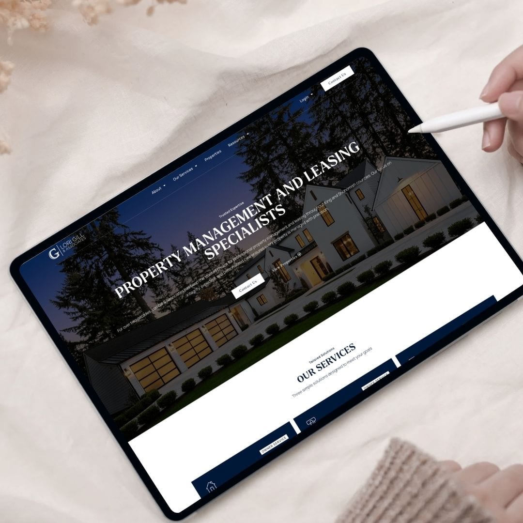 Person using stylus on tablet displaying property management website