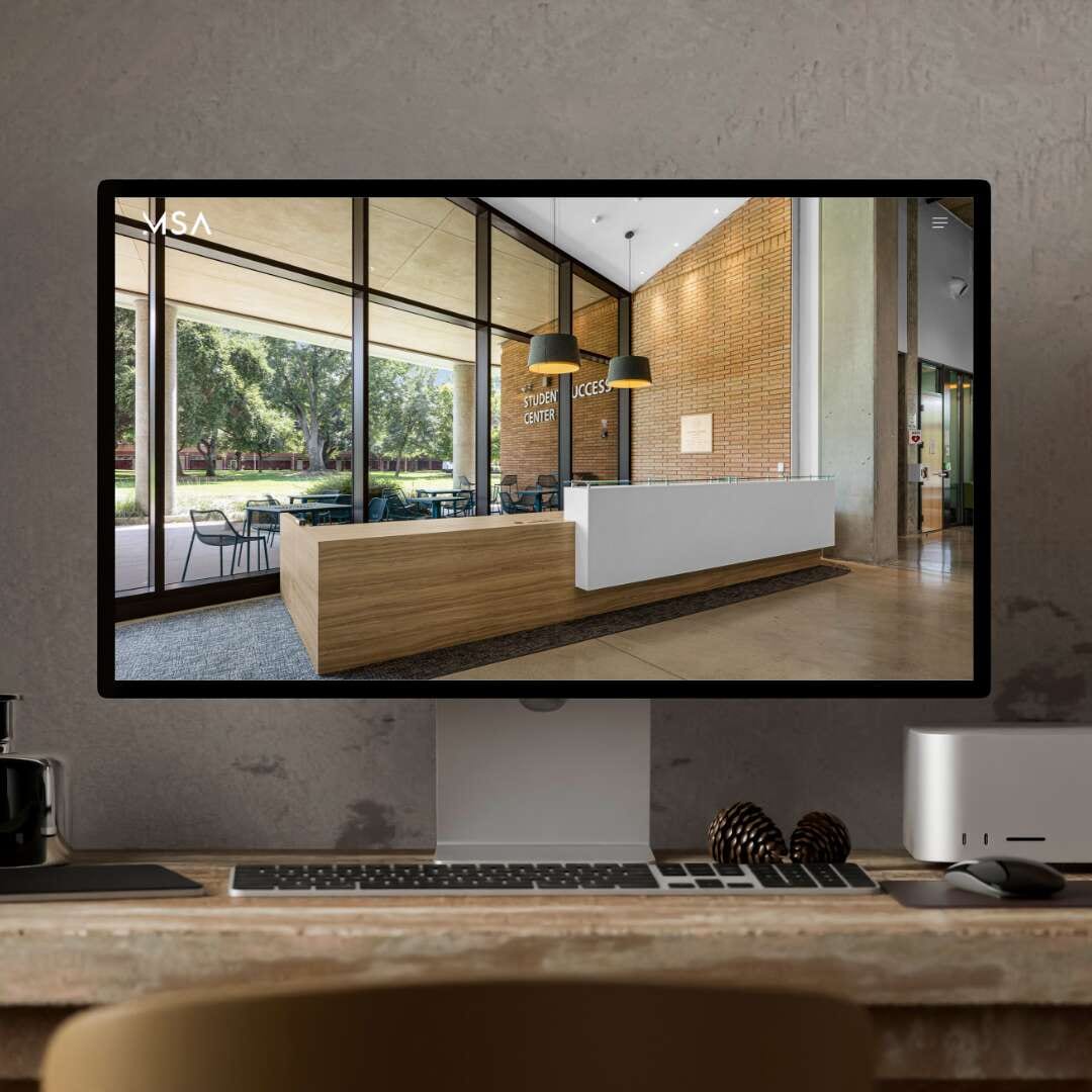 Computer monitor displaying MSA website with office interior