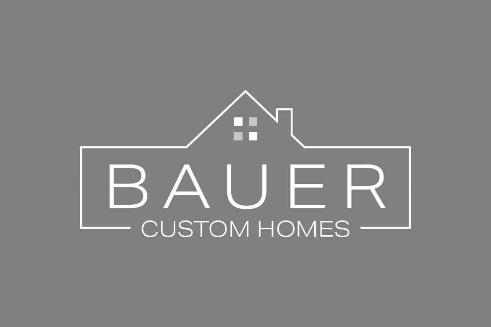 Logo on a gray background with a white house outline above the text BAUER CUSTOM HOMES. The house outline includes a simple roof and two windows.