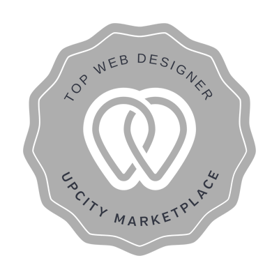 A gray badge with two interlocking shapes in the center. Text around the edge reads, Top Web Designer, UpCity Marketplace.